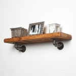 raw steel industrial pipe shelf bracket detailing reclaimed wood shelf