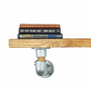 Industrial pipe with oak shelf bracket close up